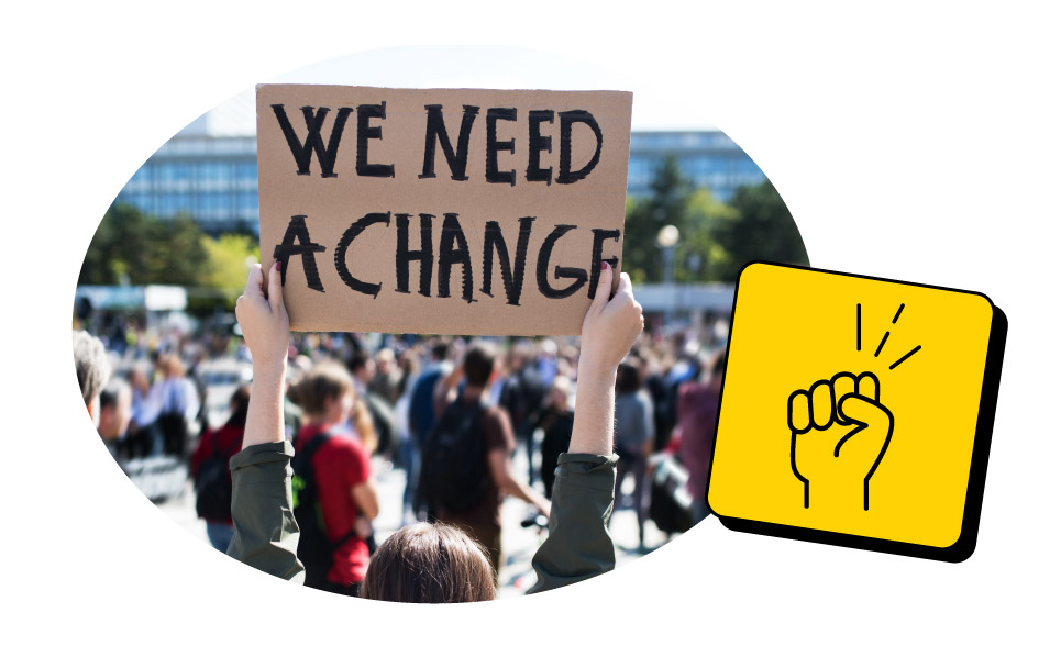 A group of protestors with focus on one who holds a sign saying 