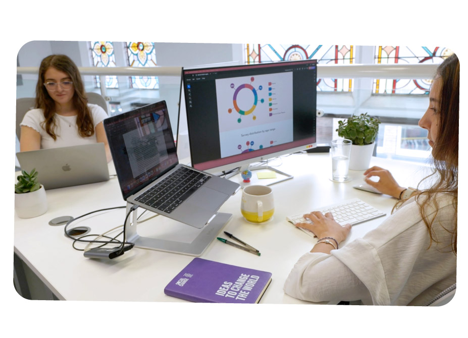 Daisy and Ana from the Behavioural Insights team working at their desks.