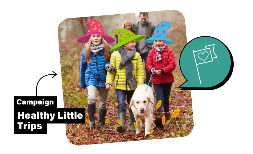 A family of five walking in an autumnal forest with a dog. The 3 children are wearing wizard hats. 
Campaign: Healthy Little Trips