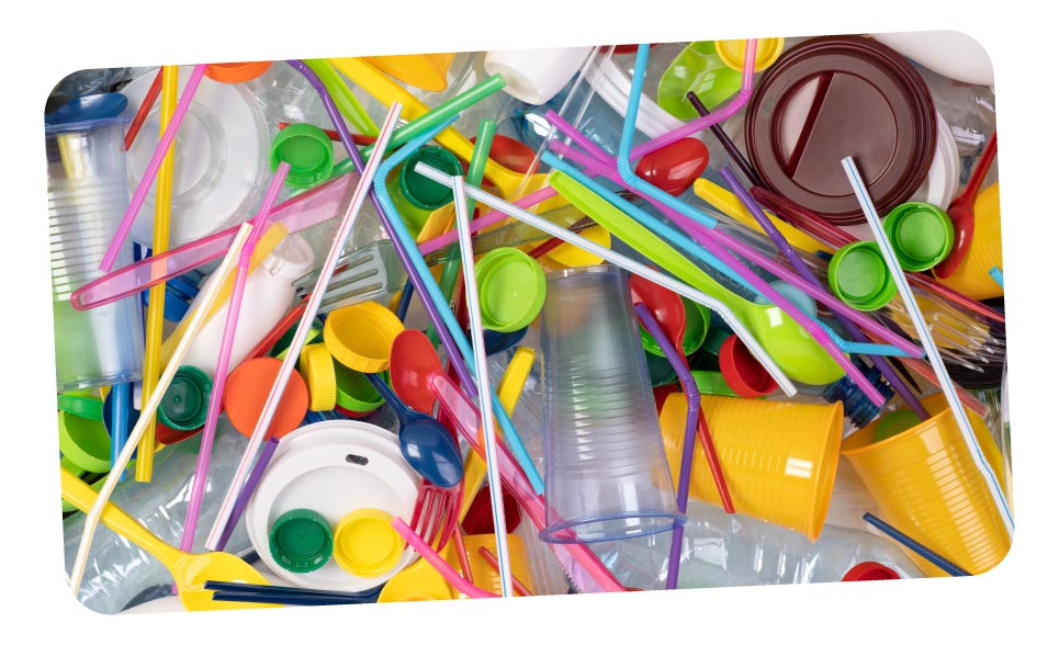 A collection of single-use plastic products like cups, forks and straws.