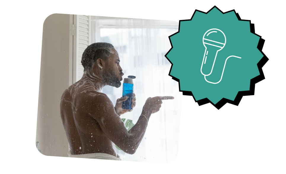 Man singing into a shampoo bottle in the shower