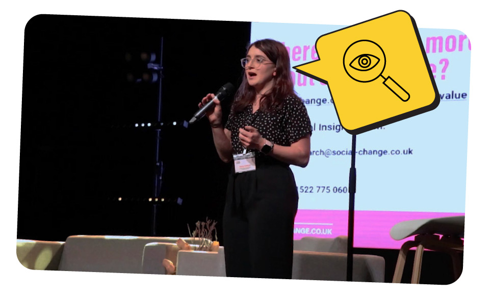 Daisy, the Head of Research, on stage at an event giving an informative talk.