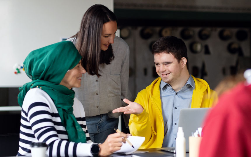 A small, but diverse group of people talking to each other in a community-space.