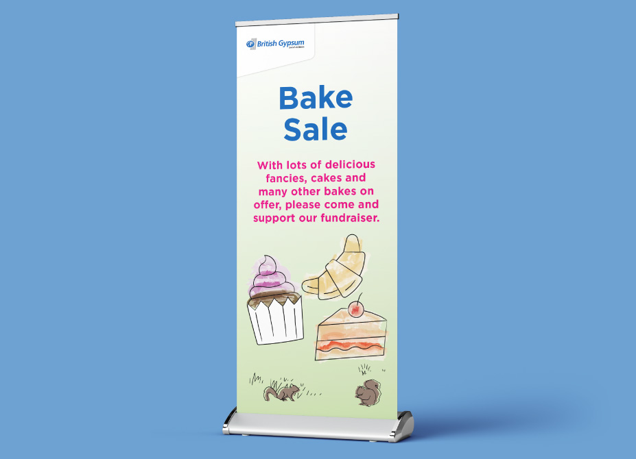 A roller banner for a British Gypsum community bake sale featuring illustrations of cakes and pastries.
