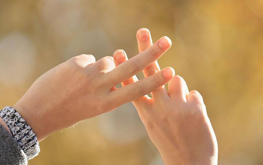 Two hands in the air, crossing two fingers on each hand over to create a hashtag sign.