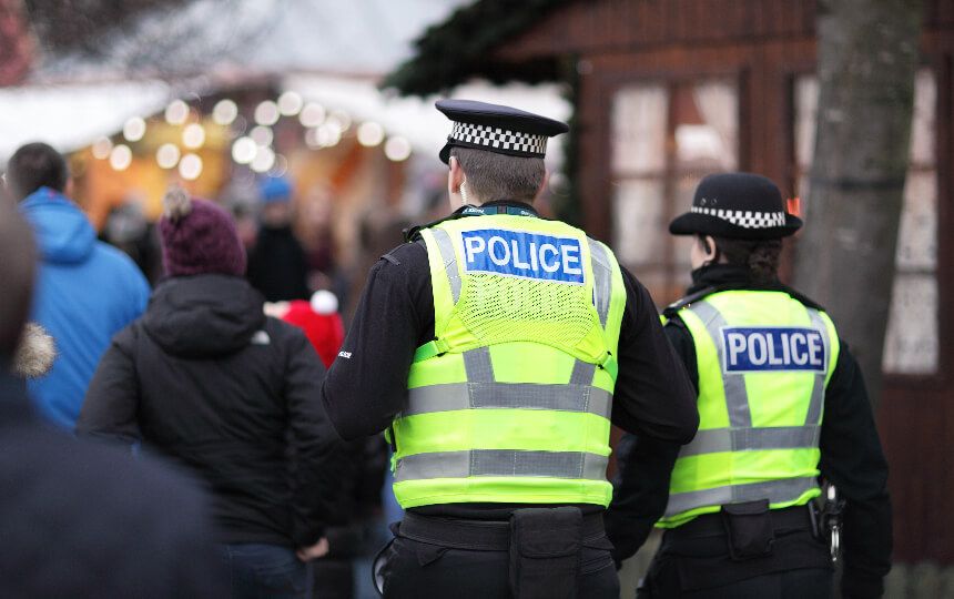A male and female police officer on patrol during a winter event.