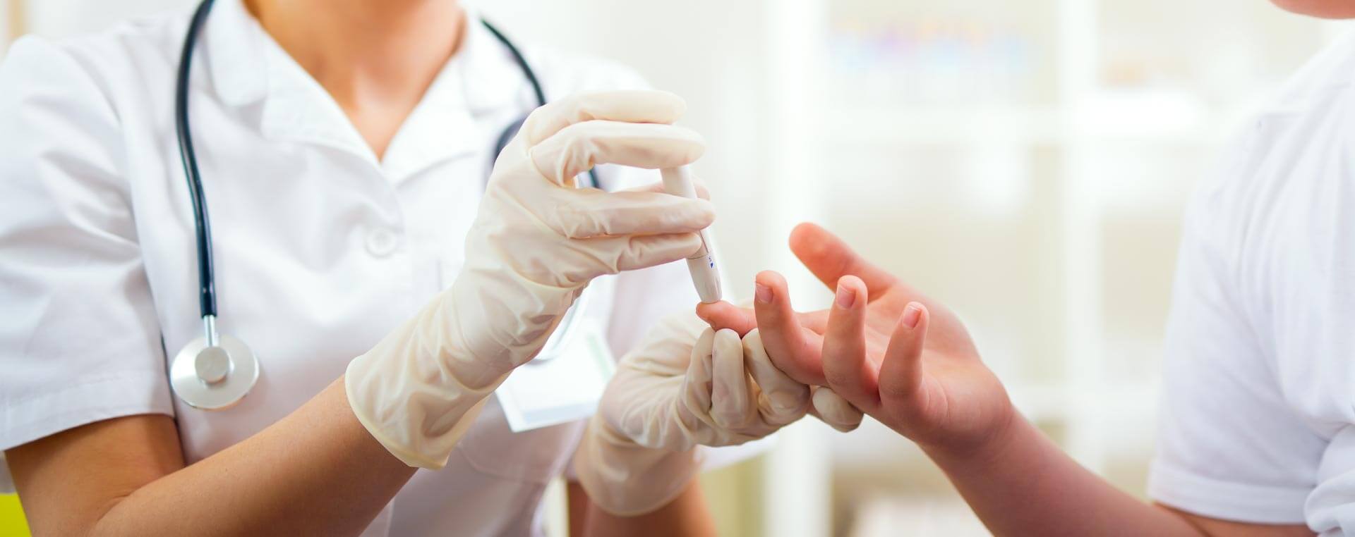 A nurse testing a patient's blood sugar levels.