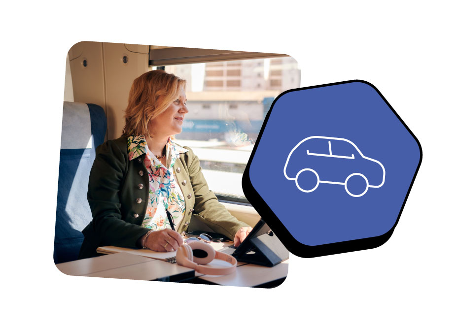 A woman sitting on a train, she is looking out the window with a pen in hand and writing on a note pad.