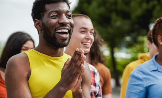 People at a pride gathering smiling