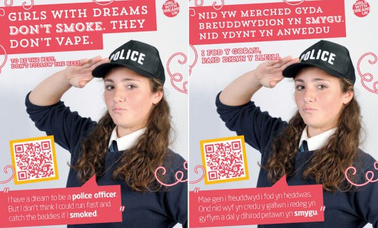English and Welsh DreamBig campaign posters showing a teenage girl saluting in a police uniform.