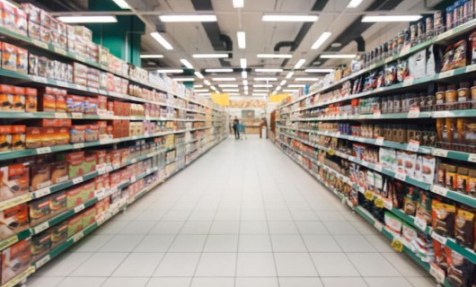 A supermarket aisle, slightly blurred.