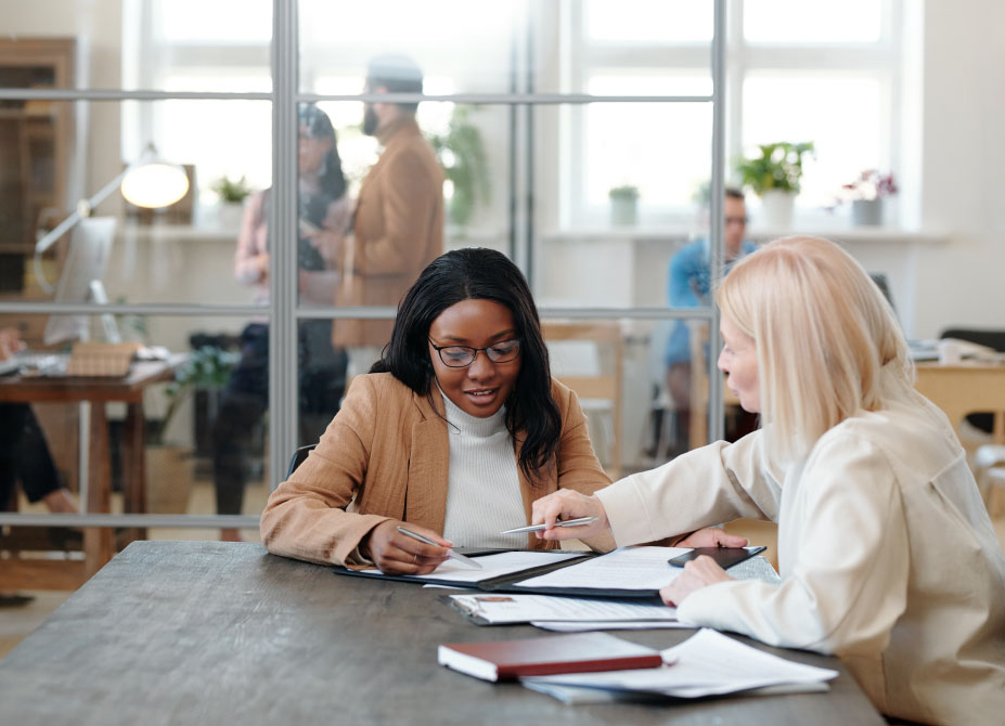 An employer discussing a contract with an employee in an office setting