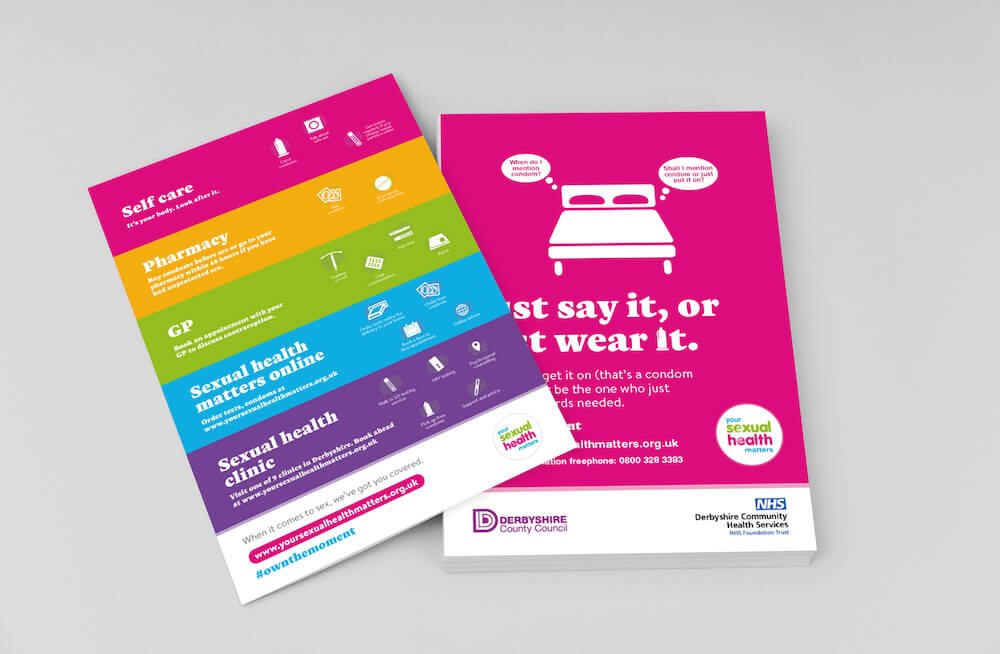 A stack of colourful flyers promoting safe sex from the Your Sexual Health Matters campaign.