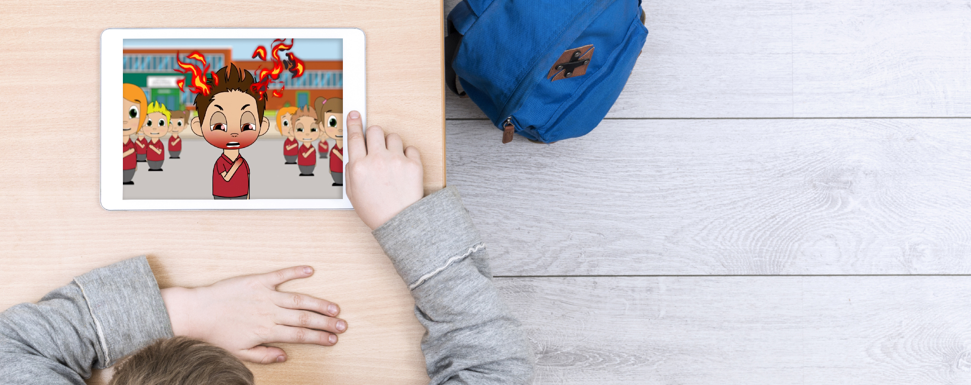 A young boy watches an Ipad on a table, showing the Just Talk mental health animation.