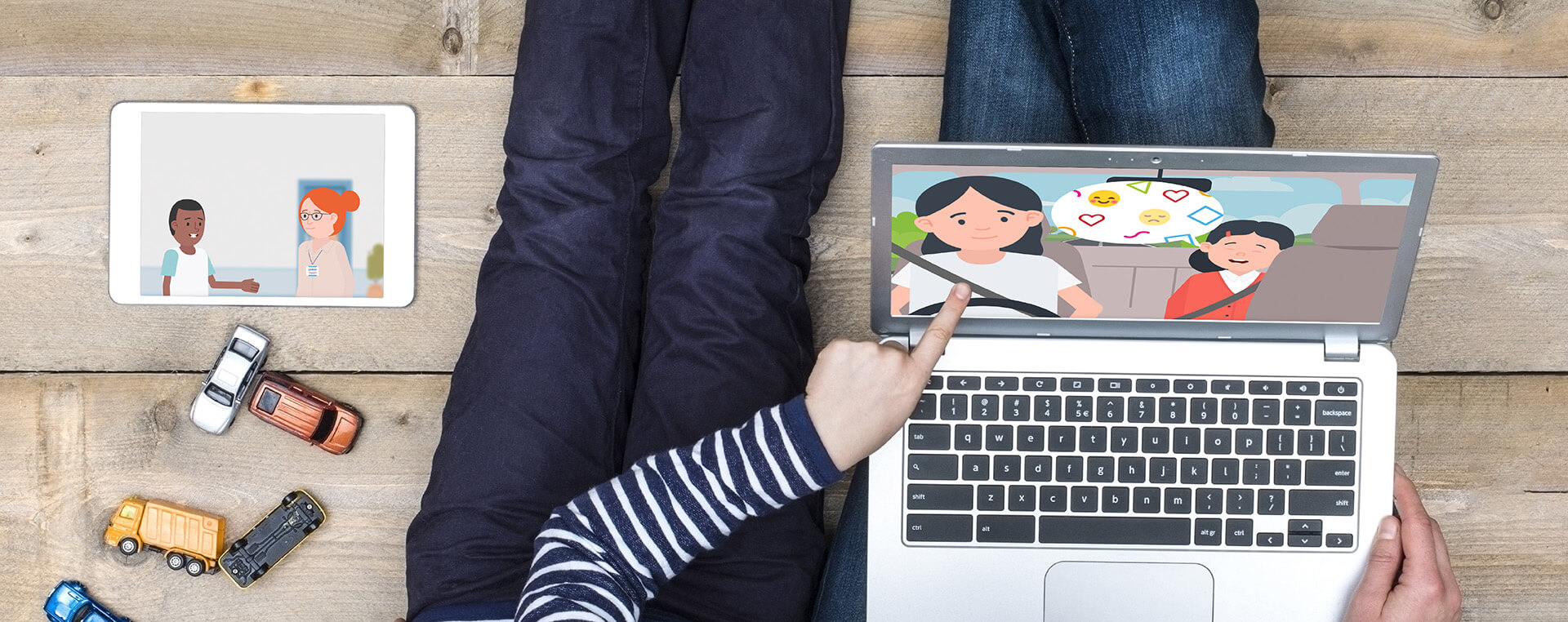 A child and mother watch the MHST animations on their laptop and tablet, the child is pointing to the screen.