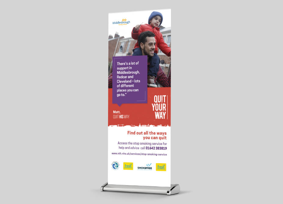 A pop-up banner featuring a man carrying his son and a quote regarding stop smoking services.