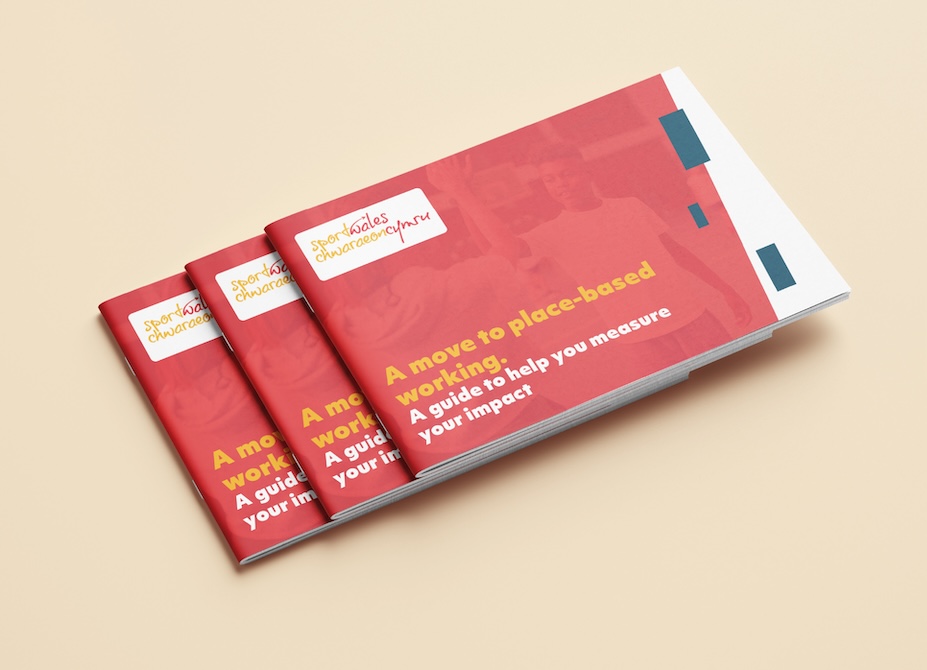 A stack of 3 printed Sport Wales strategy guides on a pale yellow surface.