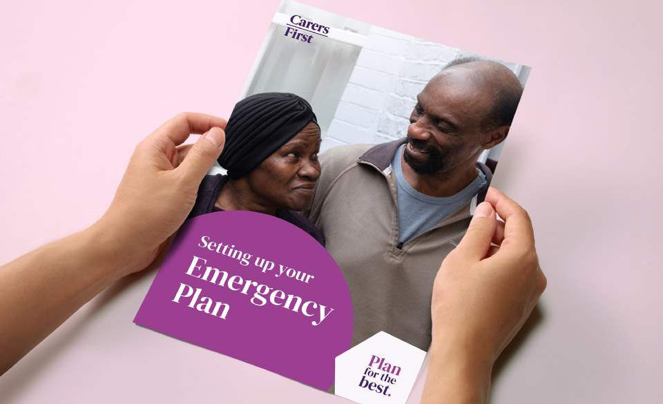 A close-up photo of a persons hands holding the emergency plan.