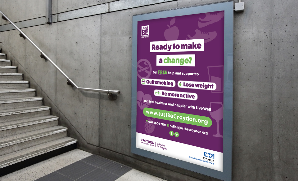 A JustBe Croydon billboard poster next to a concrete flight of stairs.