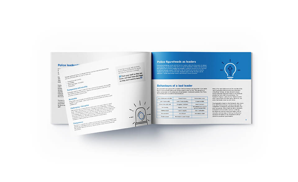 An overhead shot of the report opened on pages about police leadership and behaviours.