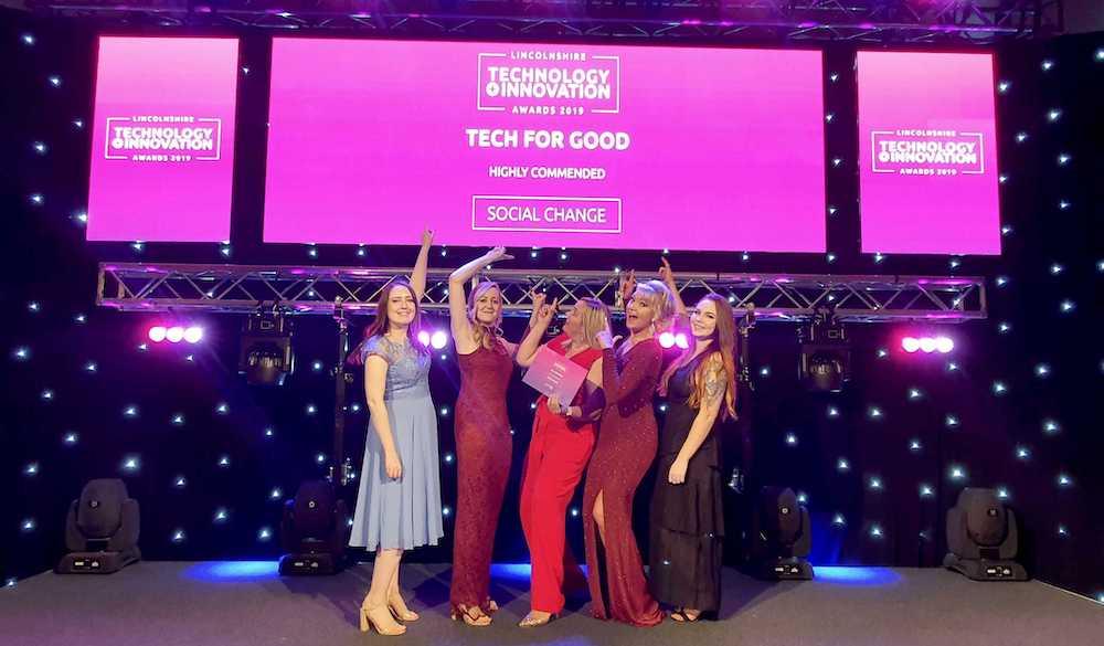 Members of Social Change UK pose with their Tech for Good 'highly commended' certificate.